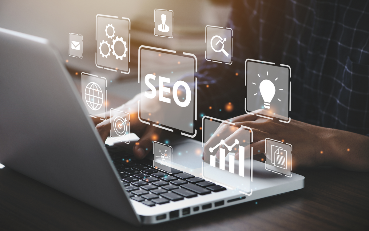 A person performs website design including SEO on their laptop.