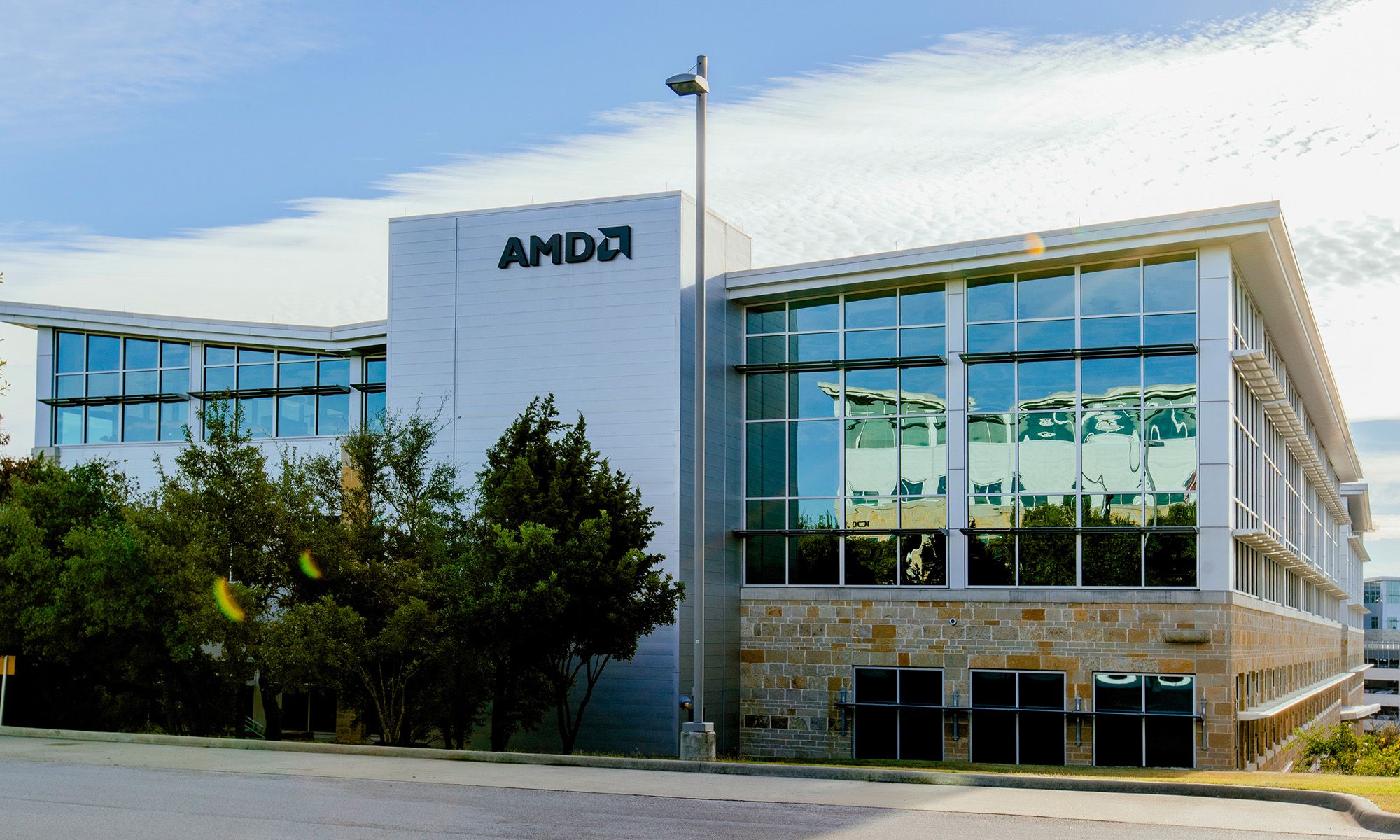 The AMD logo appears atop an office building.